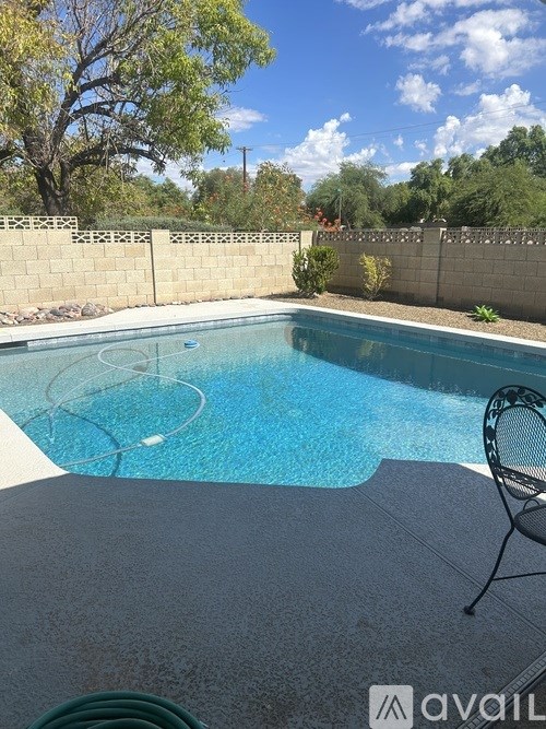 A pool with a chair and a hose.