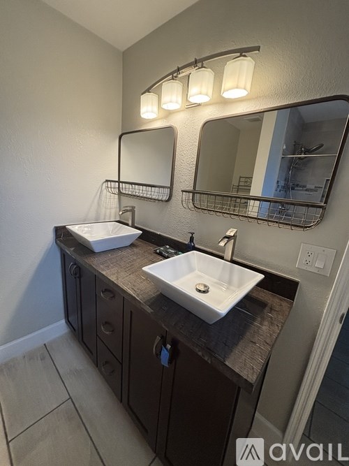 A bathroom with a sink and mirror.