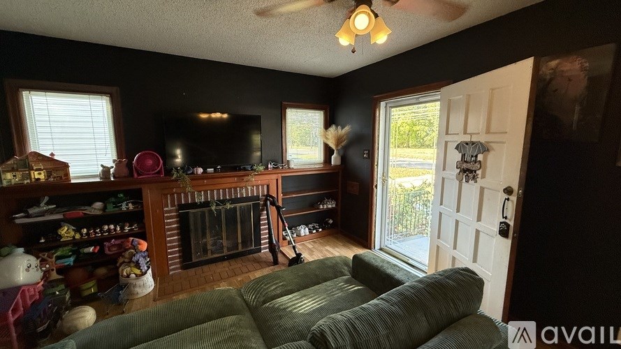 A living room with a fireplace and a television.