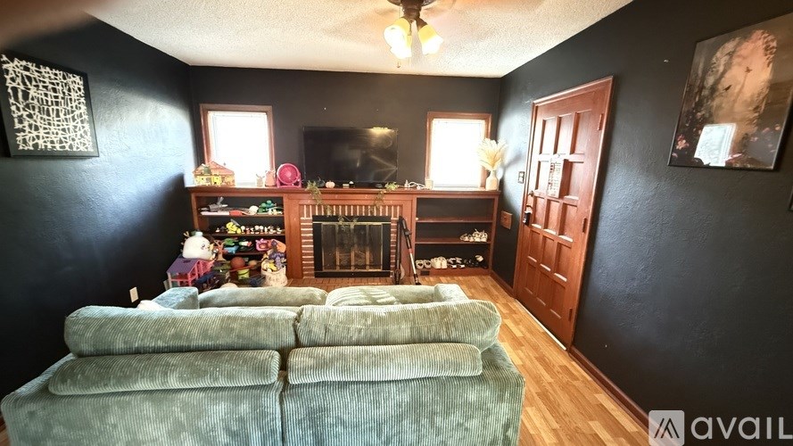 A living room with a fireplace and a couch.