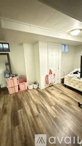 A room with wooden floors and a white door.
