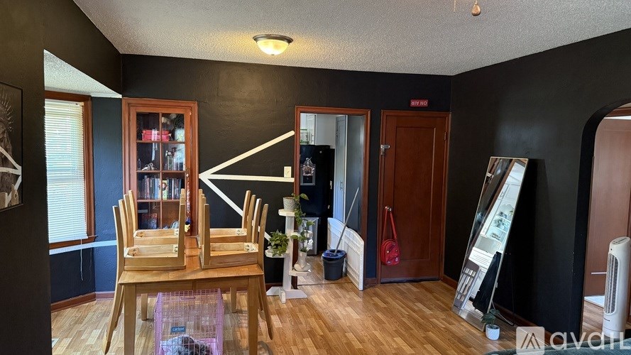 A room with a wooden table and chairs.