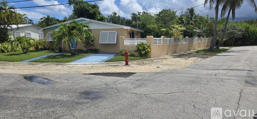 A house with a pool and a red fire hydrant in front of it.