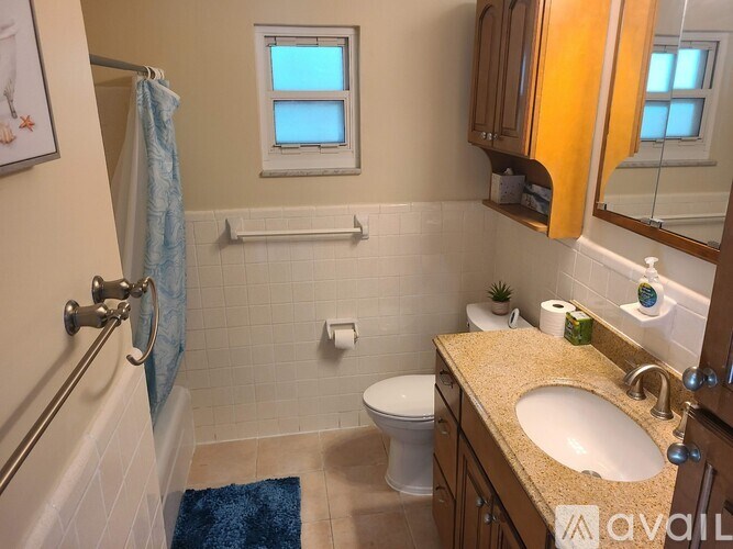 A bathroom with a sink, toilet, and bathtub.