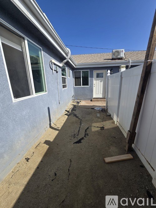 A backyard with a fence and a small shed.