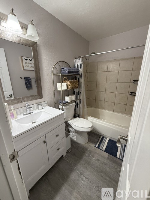 A bathroom with a white sink and toilet.