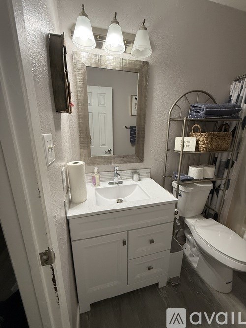 A bathroom with a white sink and toiletries on the counter.