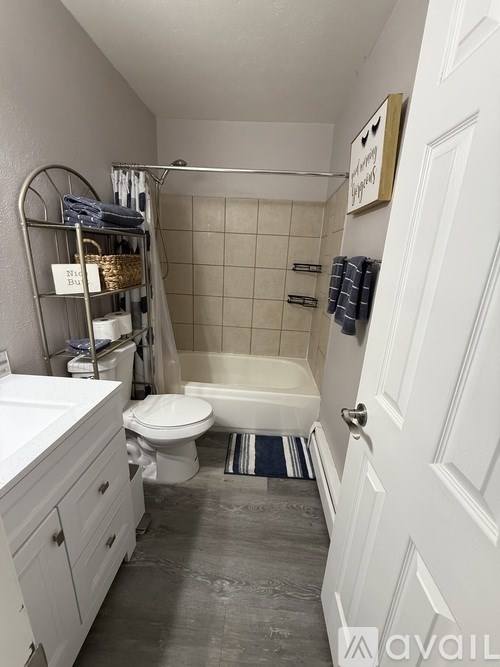 A bathroom with a toilet, sink, and bathtub.