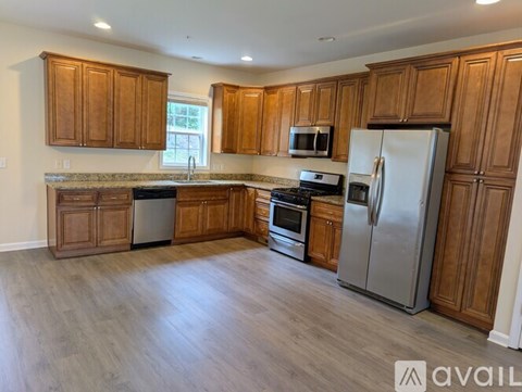 A kitchen with wooden cabinets and stainless steel appliances.