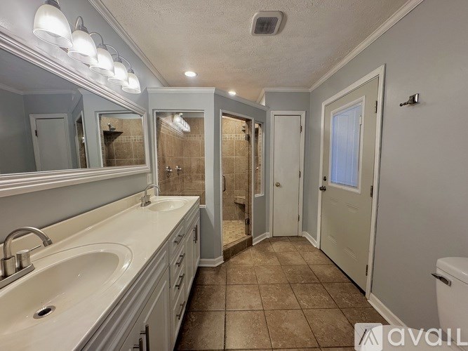 A bathroom with a sink, mirror, and toilet.