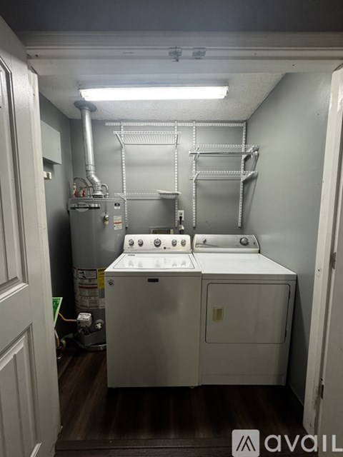 A small white kitchen with a sink and a stove top.