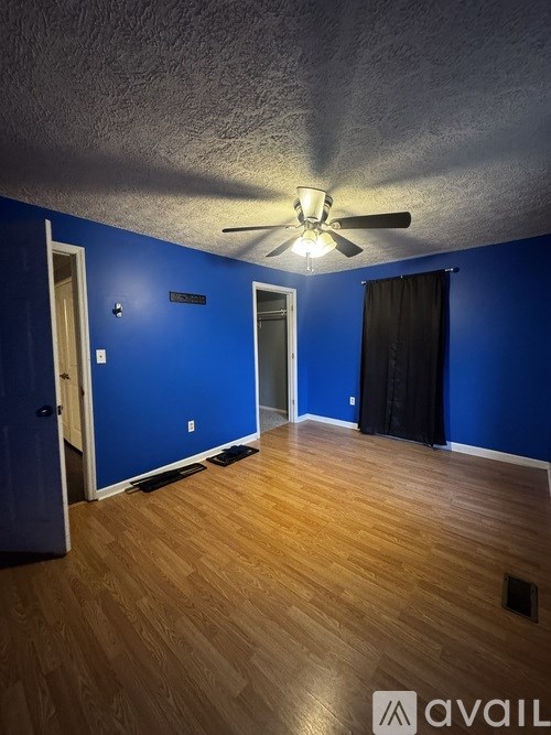 A room with blue walls and wooden flooring.