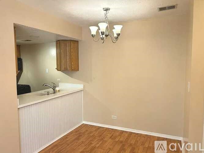 A room with a sink and a mirror on the wall.