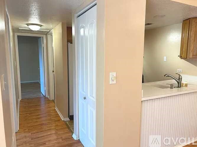 A white door is open to a hallway.