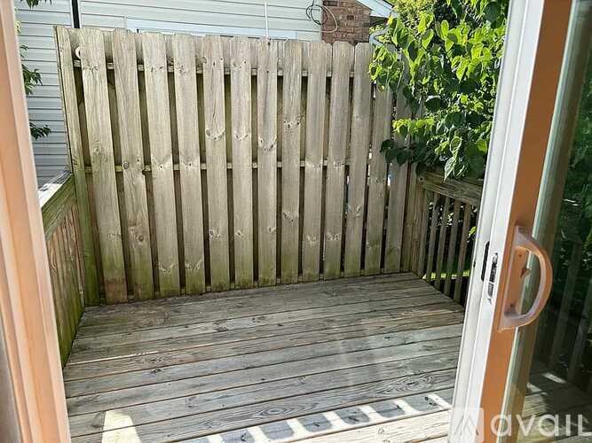 A wooden deck with a sliding glass door.