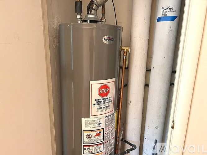 A water heater with a stop sign on it.