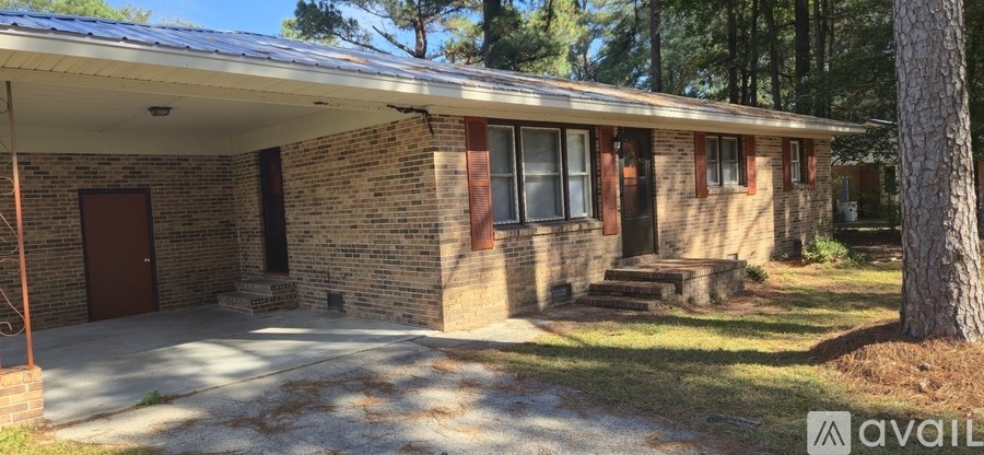 A house with a brown door and red shutters is for sale.