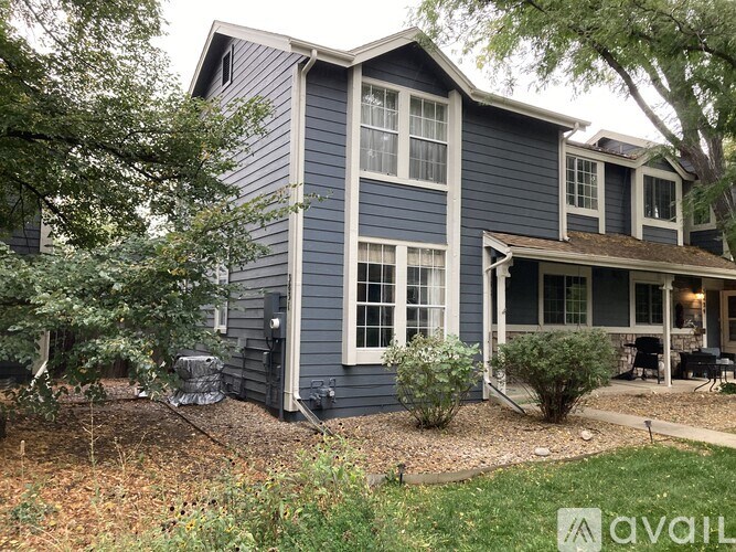 A house with a blue exterior and a covered patio.