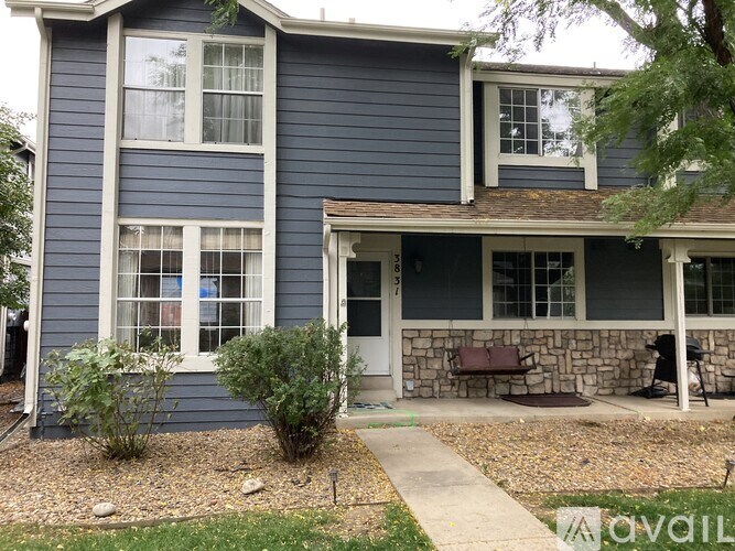 A blue house with a white door and windows.
