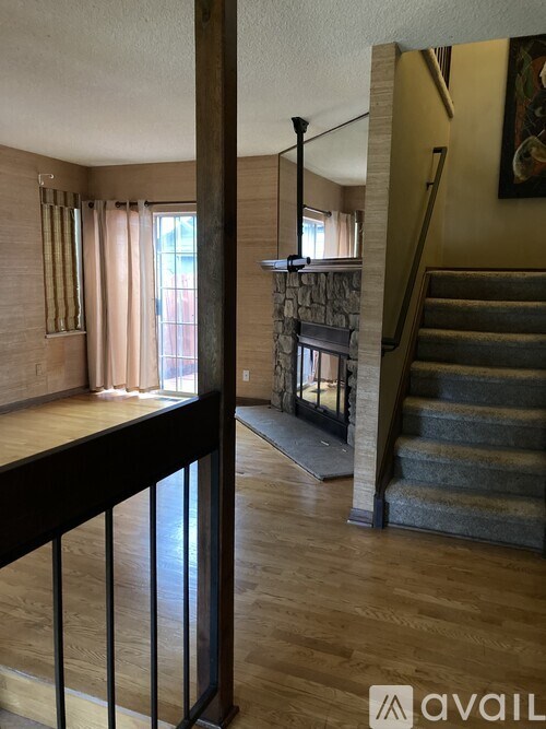 A staircase with a carpeted runner and a wooden banister.