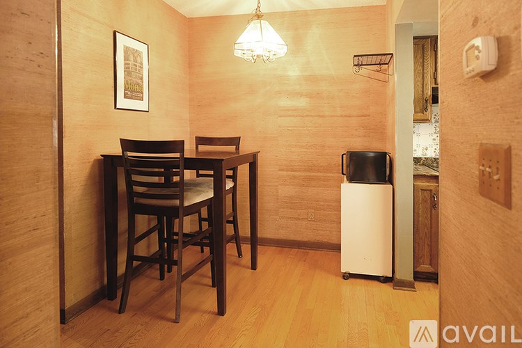 A dining area with a wooden table and chairs.
