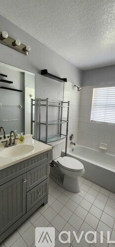 A bathroom with a toilet, sink, and bathtub.