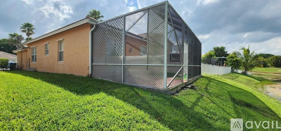A house with a metal structure attached to it is for sale.