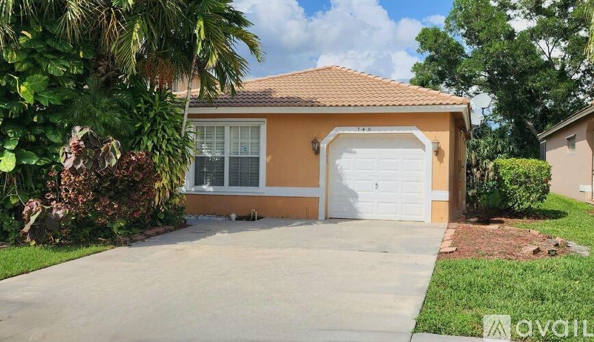A house with a brown roof and a white garage door is for sale.