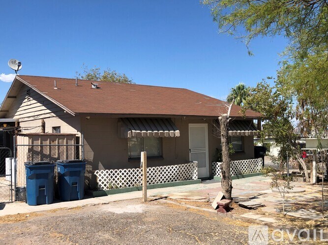 A house with a brown roof and a white fence.