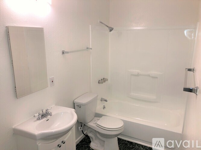 A white bathroom with a sink, toilet, and bathtub.