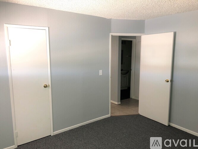 A room with three doors, one of which is open.