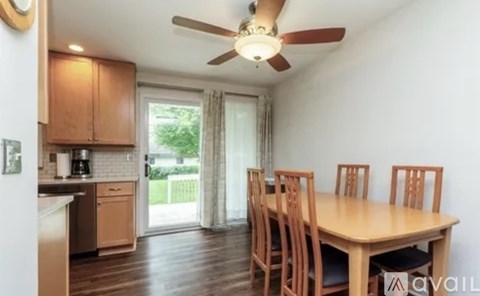 A kitchen with a table and chairs is available for rent.