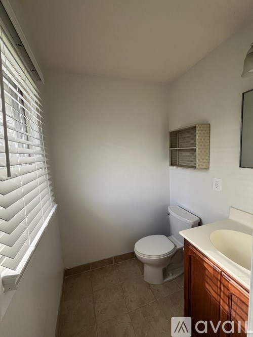 A room with a white wardrobe and wooden flooring.