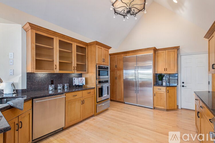 A kitchen with wooden cabinets and stainless steel appliances.