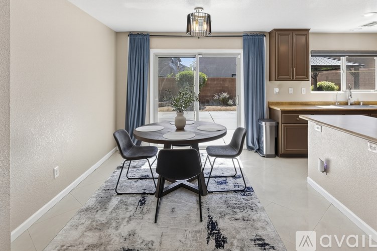 A dining area with a round table and chairs.