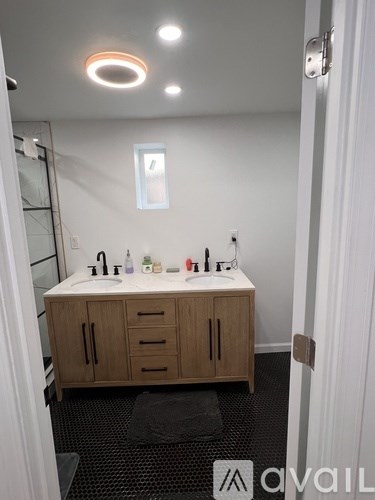 A bathroom with a sink and a mirror.