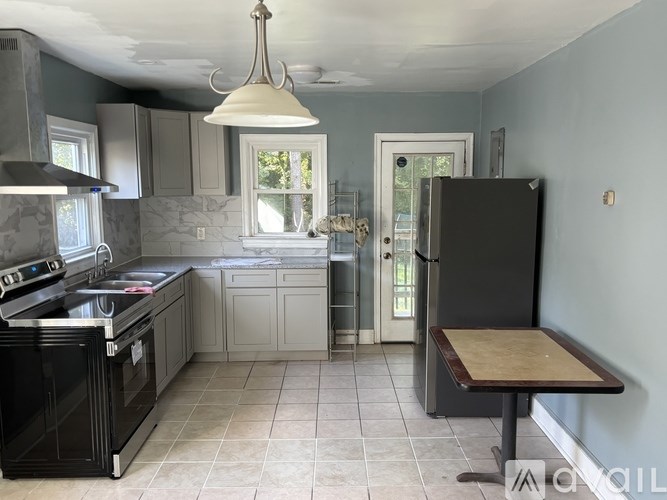 A kitchen with a black oven and a wooden table.