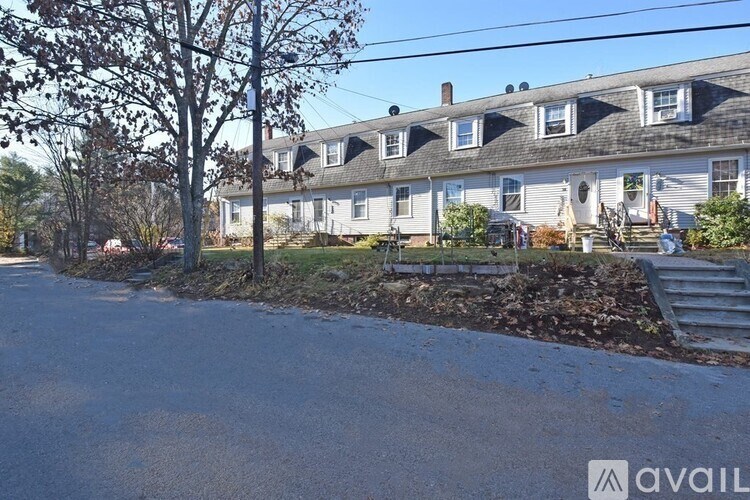 A row of houses with a tree in front of them.