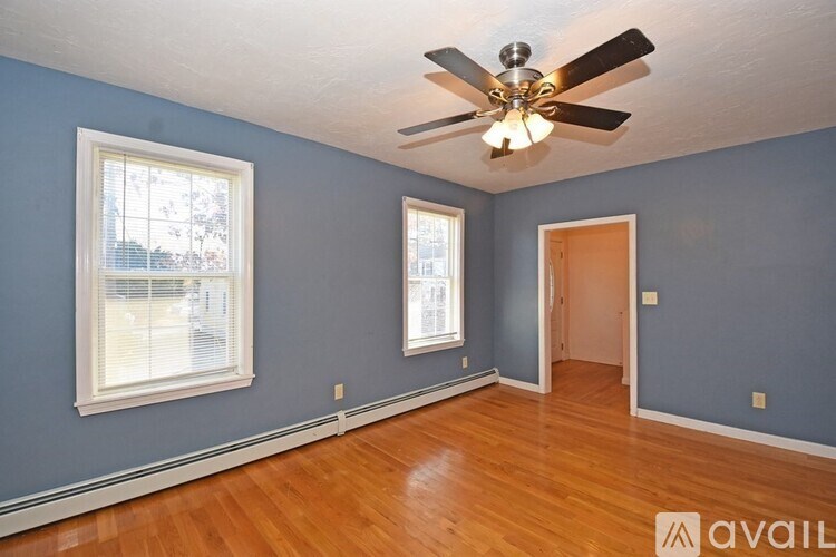A room with blue walls and a ceiling fan.