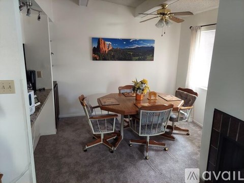 A dining room with a table set for four.