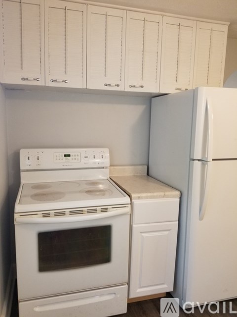 A white oven and refrigerator in a kitchen.