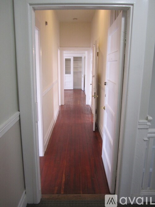 A room with wooden floors and white walls.