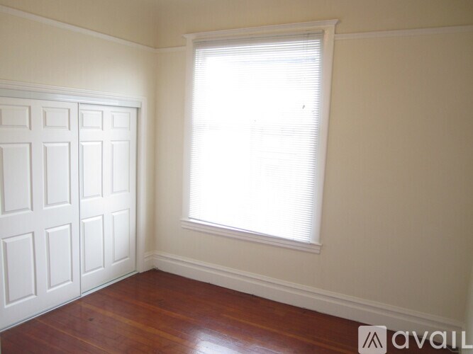 A room with wooden floors and white walls.