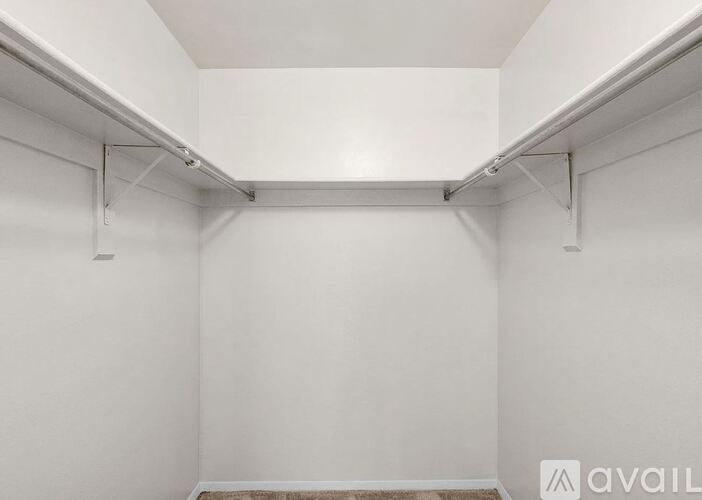 A white room with a carpeted floor and white walls.