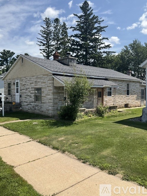 A house with a grey stone exterior and a white door.