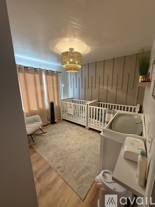 A baby's room with a crib and a changing table.