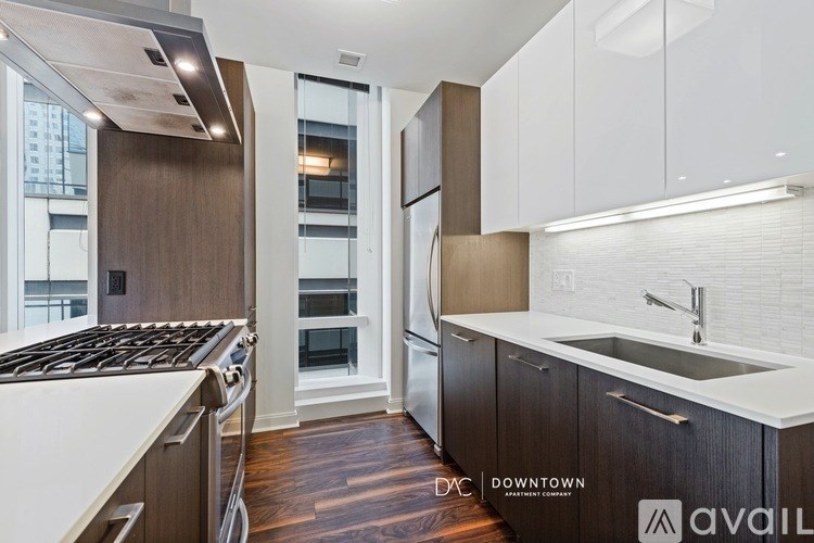 A kitchen with a stove top oven and a sink.