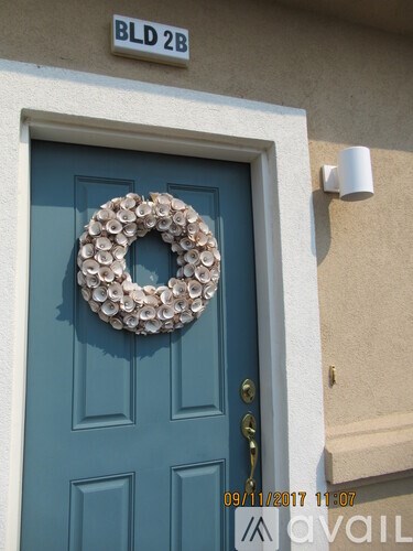 A blue door with a wreath on it.