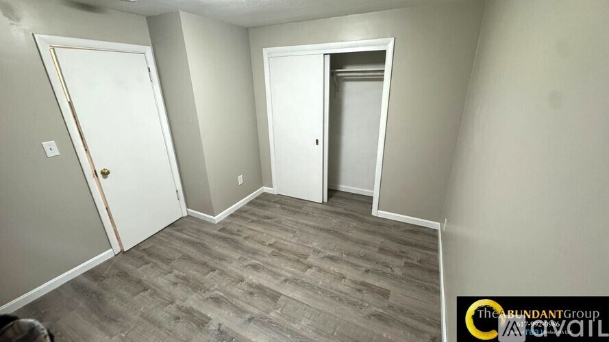 A room with two doors and a wooden floor.