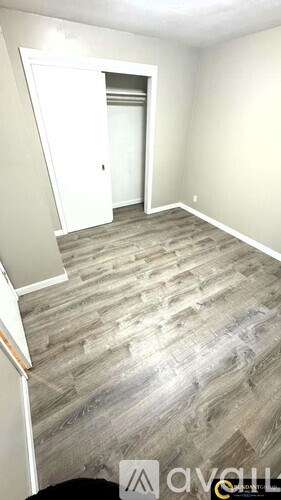 A room with a wooden floor and a white door.
